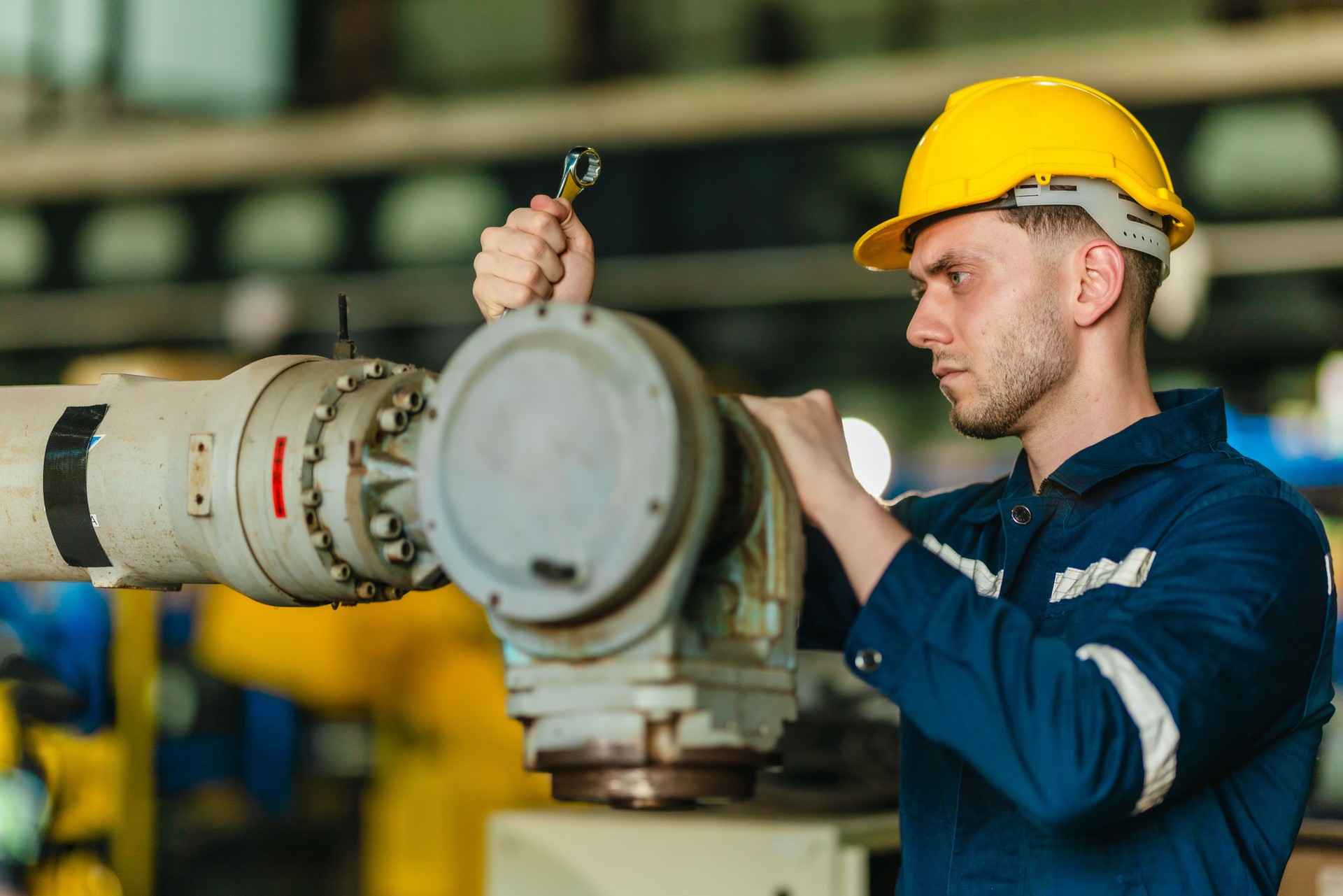 Technician Servicing Industrial Robot Arm